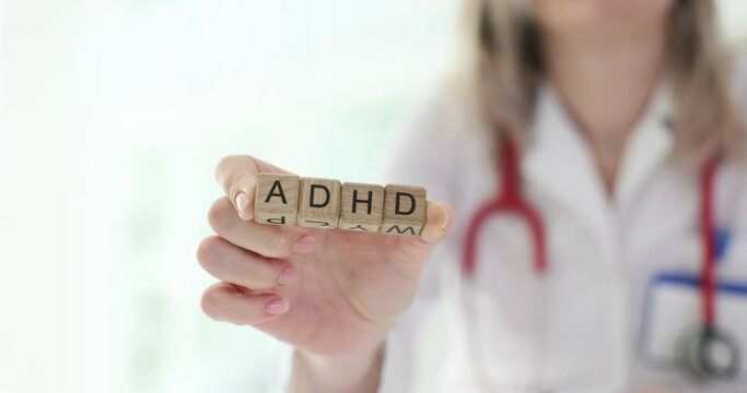 Doctor holding wooden blocks with ADHD inscription