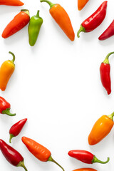 Close top down view on colorful mini bellpeppers in shape of a frame on white background. Vegetable...