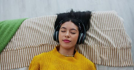 Above, music and girl in bed for relaxing, resting and comfortable while sleeping in home. Audio, radio and podcast with headphones by person in bedroom, daydreaming and chilling with playlist