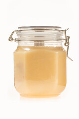A bottle of Russian linden honey on a white background