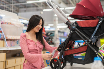 Mother woman carefully examines a modern, decision making stroller in spacious baby store, mindful parent, seeking quality and safety in children products family planning, baby care products, shopping