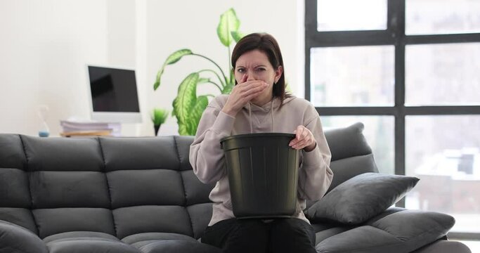 Young woman suffers from nausea at home