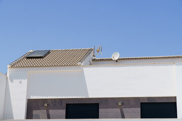 roof of a house installing solar panels with a blue sky background