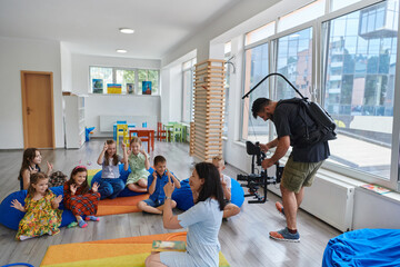 Cameraman films the joyful play and creative exploration of children at a preschool