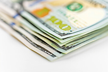 A high-resolution photograph of a stack of hundred-dollar bills