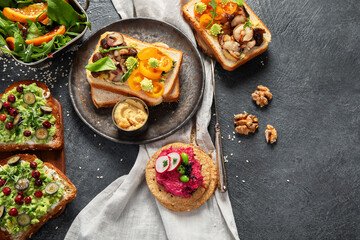 Vegan toast with avocado,mushroom and fresh salad on dark background. Vegetarian food concept