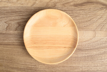 A wooden plate on wooden background, Kitchen utensil, Table top view