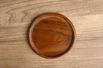 A wooden round coasters on wooden background, Table top view