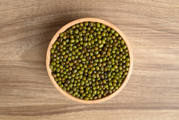Organic mung bean seed in bowl on wooden background, Table top view