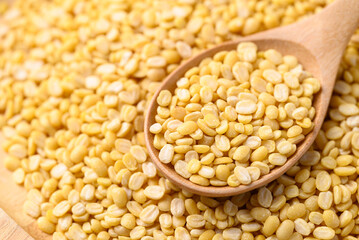Yellow peeled split mung bean in wooden spoon, Food ingredient