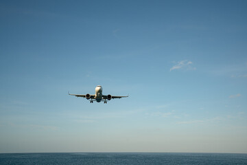Landing passenger jet airplane at daytime.
