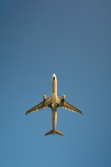 Bottom view of passenger jet airplane take off from an airport at daytime