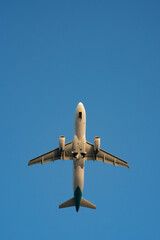 Bottom view of passenger jet airplane take off from an airport at daytime