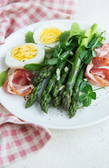 Fresh Asparagus and Prosciutto Salad Served With Boiled Eggs and Microgreens