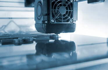 3D printer working close-up. 3D printer prints model from molten plastic close-up. 3D printer...