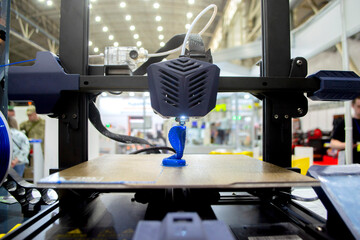 3D printer working close-up. 3D printer prints model from molten plastic close-up. 3D printer printing object. Additive progressive high-tech technology. New modern prototyping technologies.