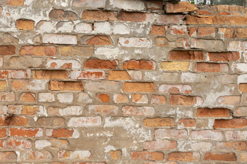 Old, broken brick wall texture. Abandoned, ruined building in Latvia, Europe. Artistic wall texture.
