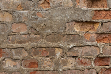 Old, broken brick wall texture. Abandoned, ruined building in Latvia, Europe. Artistic wall texture.