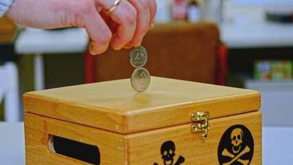 Trick with coins. Stock footage. Close-up of man puts coins on top of each other vertically. Trick...