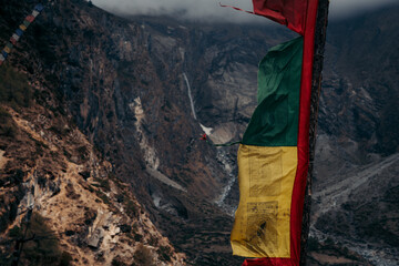 Prayer flag and waterfall during Tsum Valley Trek, Nepal