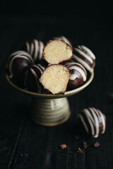 Close-up view of chocolate candies with green pistachio filling inside at black background