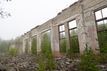 An old, collapsed building in soviet army base in Latvia, Europe. Abandoned white brick building.