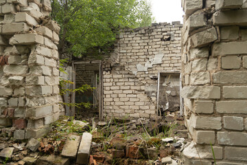 An old, collapsed building in soviet army base in Latvia, Europe. Abandoned white brick building.