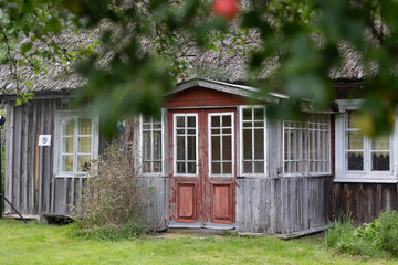 An old, wooden log building in countryside of Latvia, Europe. Wooden architecture.