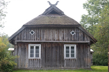 An old, wooden log building in countryside of Latvia, Europe. Wooden architecture.
