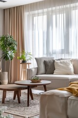 A modern living room with stylish furniture, a large window with curtains, and decorative elements like plants and art. The natural light brightens the space, making it feel open and welcoming.