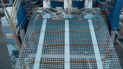 Industrial production of plastic mesh. Creative. Winding of industrial polymer mesh on coils....