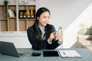 Business woman using tablet and laptop for doing math finance on an office desk, tax