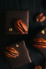 Halva in chocolate at dark background with nuts
