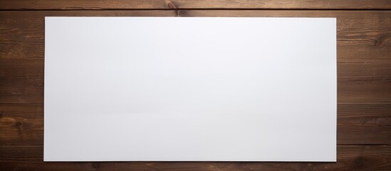 Obraz premium The background of the photo features a white paper on a wooden table leaving some empty space for adding any desired image. Creative banner. Copyspace image