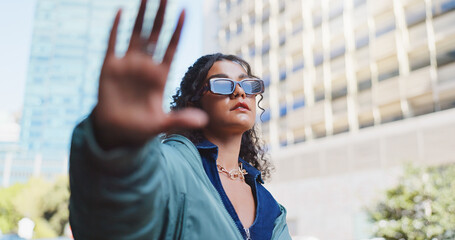 Woman, hand frame and edgy with sunglasses in city for trendy style, designer brand or streetwear....