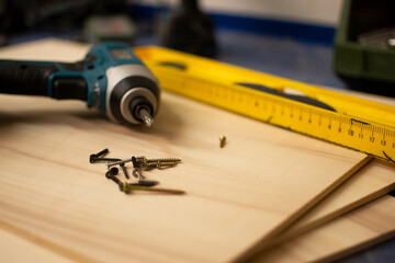 SCREWDRIVER AND WOODEN BOARD