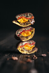 A still life of candies made of dehydrated fruits in dark chocolate at dark background
