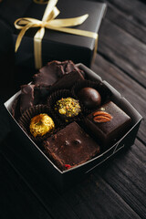A box of assorted chocolate on a black background