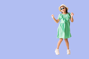 Happy smiling asian little girl and jumping, dancing were hat and sunglasses posing, Fashion summer holiday concept, Full body isolated on purple background