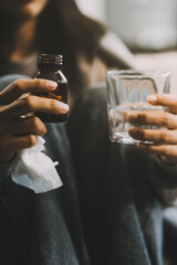 Upset woman frustrated by problem with work or relationships, sitting on couch, embracing knees, covered face in hand, feeling despair and anxiety, loneliness, having psychological trouble