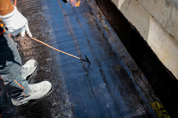 Worker using a gas burner, propane blowtorch to melt and arrange resin