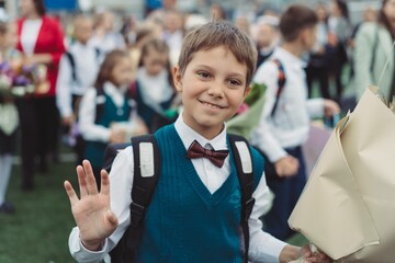 cute caucasian boy wearing school uniform on first september. knowledge day