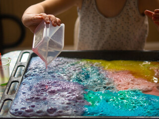 a child makes experiments with chemicals. experiments with soda and citric acid
