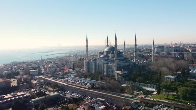 Iconic Blue Mosque in Istanbul, Turkey, with its majestic domes, minarets, surrounded by the cityscape and historic landmarks. Aerial drone footage, Istanbul, Turkey - İstanbul, T&uuml;rkiye