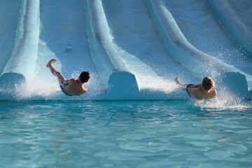 Two People Enjoying a Swim in the Water on a Sunny Afternoon