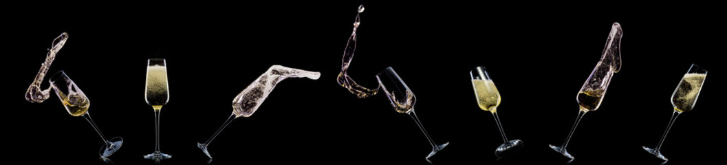 Glass for champagne with splashes isolated on black background.