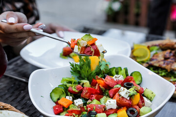 Person Eating Green Salad With a Fork