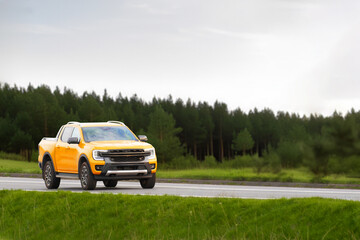 Fototapeta premium Vibrant sunset drive - pickup truck on country road.