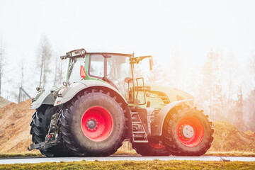 Slow-moving tractor on road to rural farming area