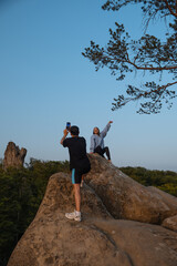 Fototapeta premium happy couple having date at the cliff on sunset